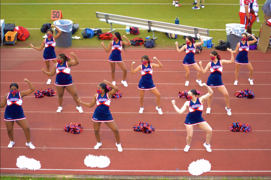 Cheerleaders+perform+for+football+fans+with+masks+on.+