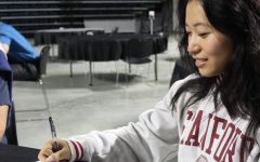 Lauren Koong signing during the HISD UIL Academics Signing Day