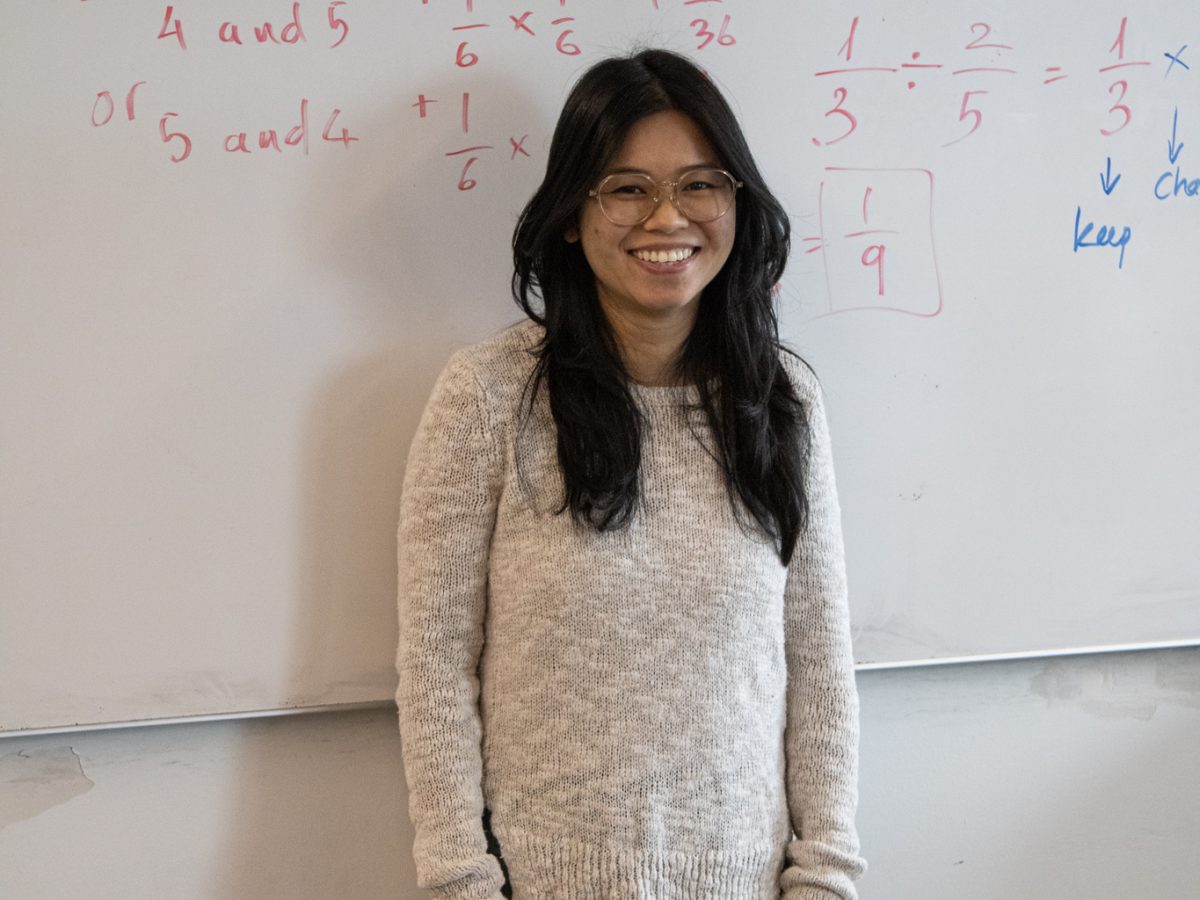 Mrs. Nguyen helps her students in her math class understand the work more.