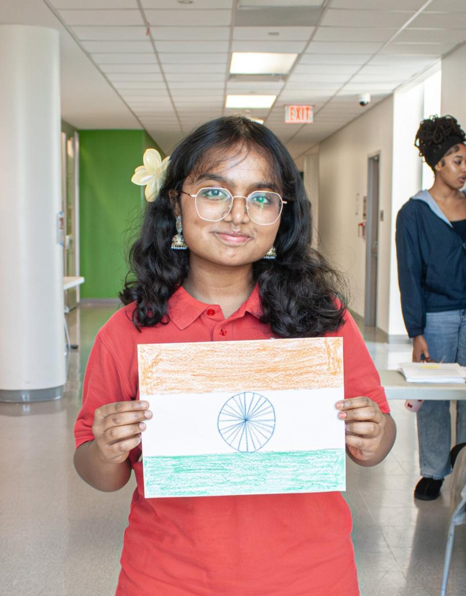 Senior Nihaarika RoshanRaj representing her country by holding a drawn flag of India. 